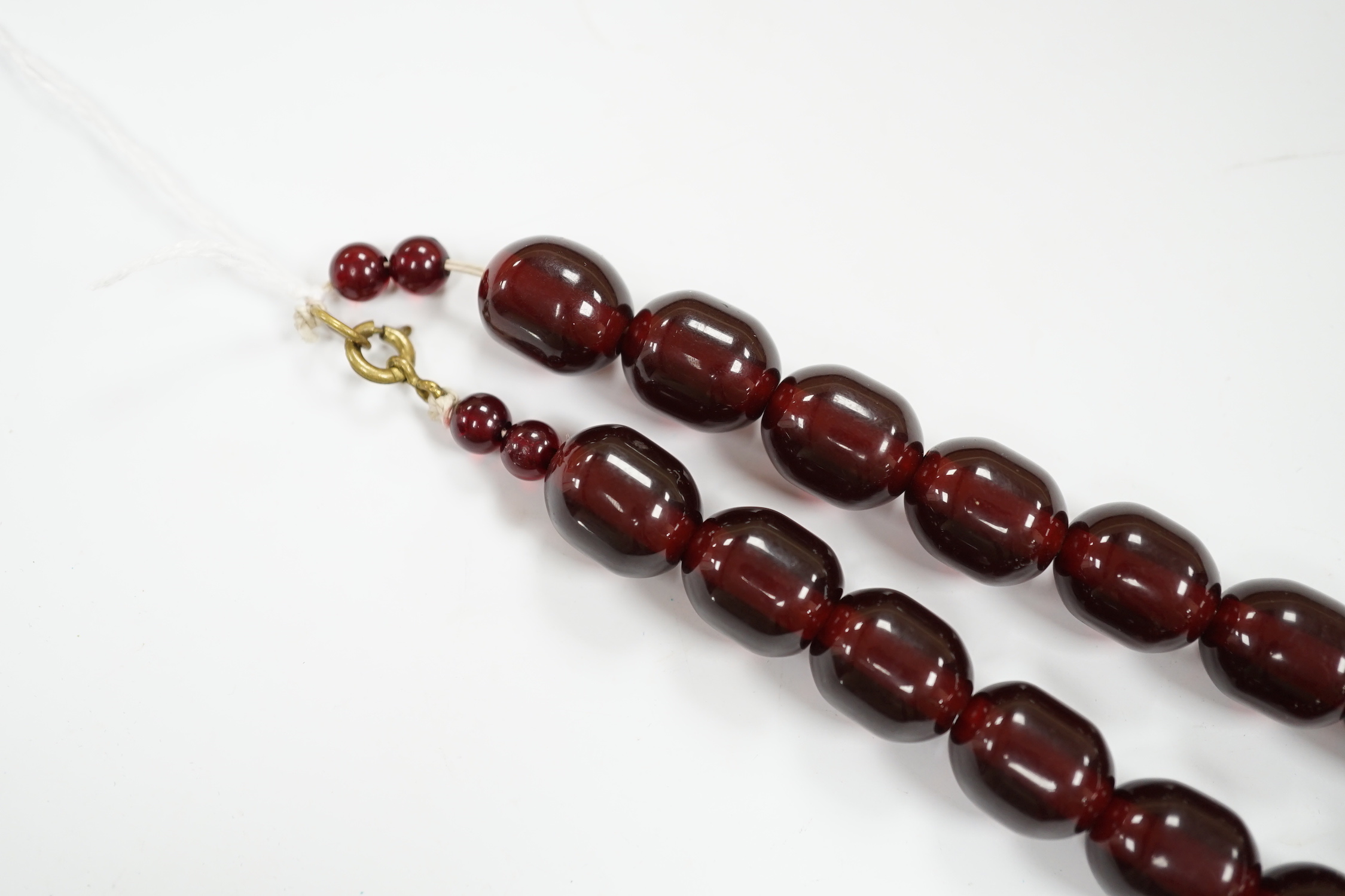 A single strand graduated simulated cherry amber bead necklace, 68cm, gross weight 151 grams.